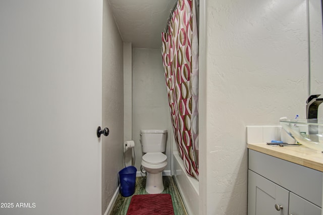 full bathroom with vanity, shower / bath combo with shower curtain, and toilet