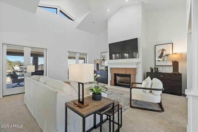 living room with light colored carpet, a fireplace, high vaulted ceiling, and french doors