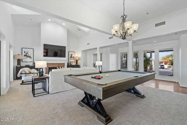 recreation room featuring a brick fireplace, light carpet, high vaulted ceiling, and billiards