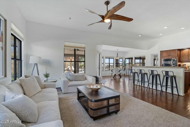 living room with ceiling fan, a healthy amount of sunlight, and dark hardwood / wood-style flooring