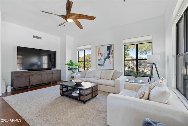 living room with wood-type flooring and ceiling fan