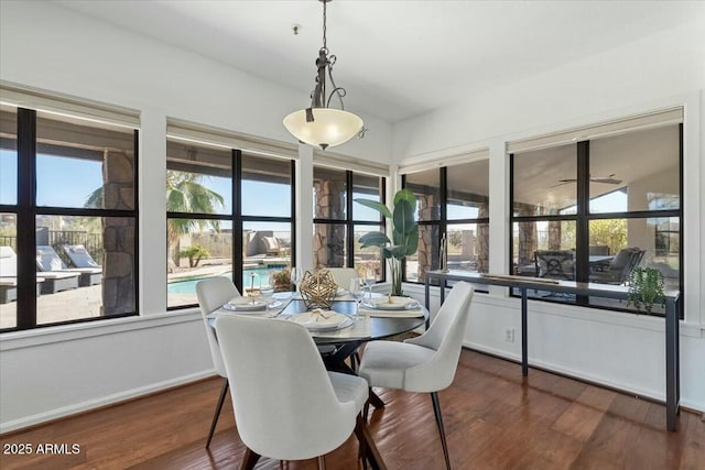 dining room with dark hardwood / wood-style flooring and a healthy amount of sunlight