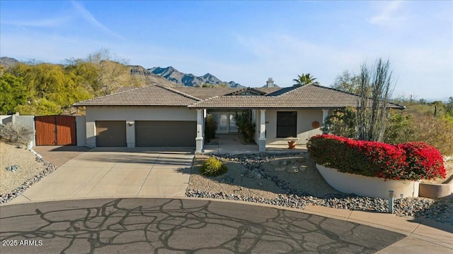 view of front of property with a garage and a mountain view