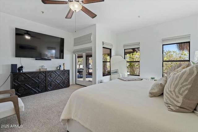 carpeted bedroom with ceiling fan and access to exterior