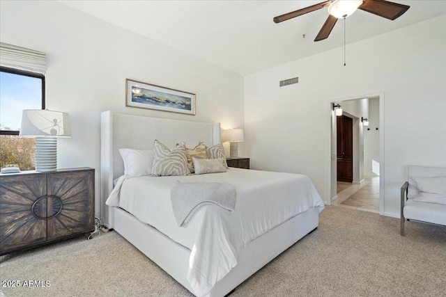 bedroom featuring light colored carpet and ceiling fan