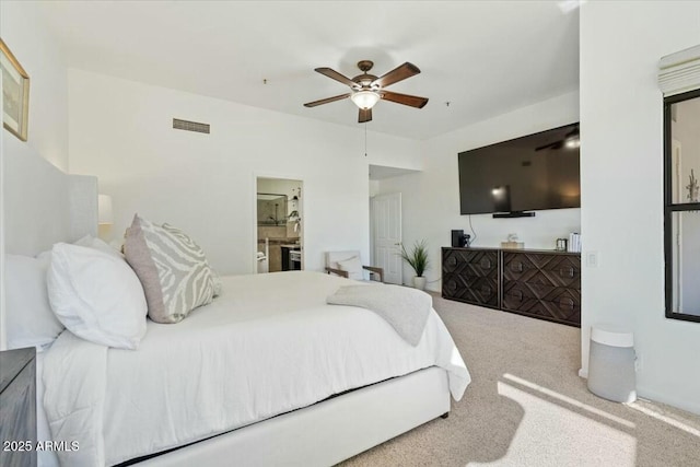 carpeted bedroom featuring ceiling fan and ensuite bathroom