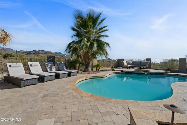 view of pool with a mountain view, outdoor lounge area, and a patio