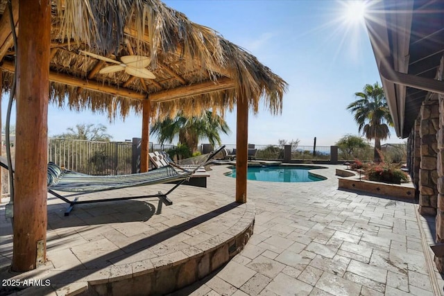 view of swimming pool featuring a gazebo, ceiling fan, and a patio area