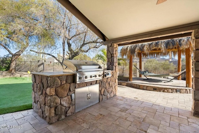 view of patio / terrace featuring a gazebo, an outdoor kitchen, and grilling area