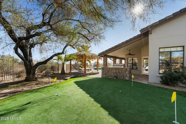 view of yard featuring a patio area and ceiling fan