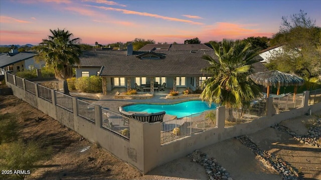 pool at dusk with a patio