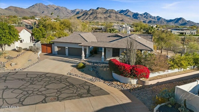 view of front facade featuring a garage and a mountain view