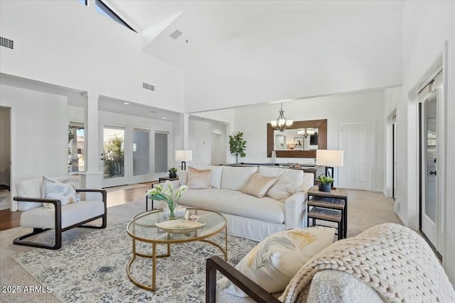 living room with a notable chandelier and high vaulted ceiling