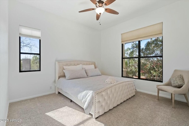 bedroom featuring ceiling fan and light carpet