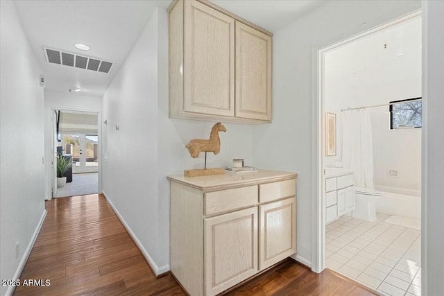 corridor with hardwood / wood-style flooring