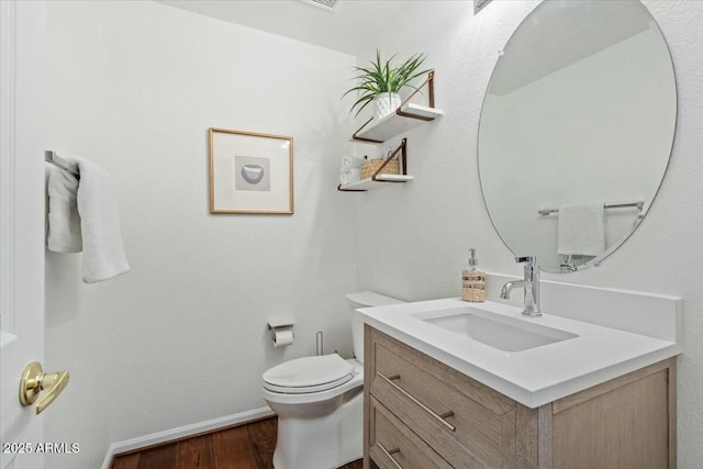 bathroom featuring vanity, hardwood / wood-style floors, and toilet