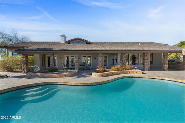 view of swimming pool featuring a patio area