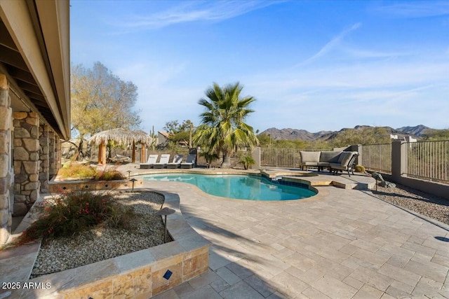 view of pool featuring a mountain view and a patio area