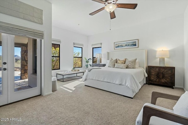 bedroom with multiple windows, access to outside, light colored carpet, and ceiling fan