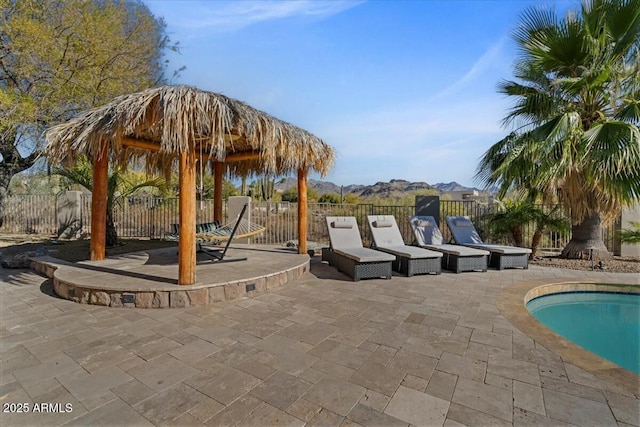 view of patio featuring a fenced in pool and a gazebo