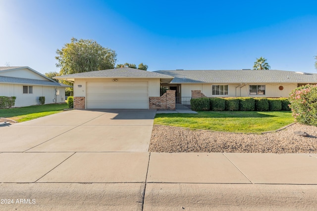 single story home featuring a front yard and a garage