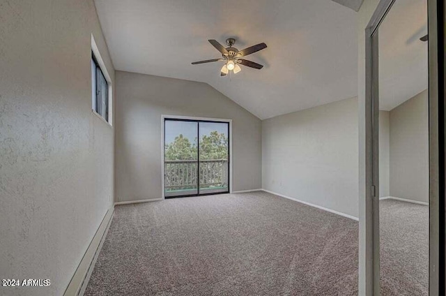 interior space featuring ceiling fan, vaulted ceiling, and carpet flooring