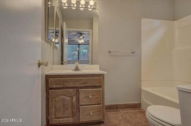 full bathroom with ceiling fan, vanity, toilet, tile patterned floors, and washtub / shower combination