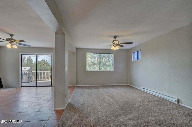 tiled empty room with a textured ceiling, ceiling fan, and a baseboard radiator