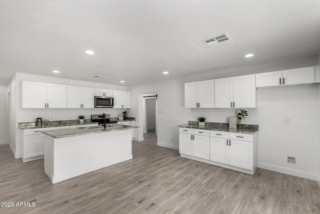 kitchen with appliances with stainless steel finishes, baseboards, visible vents, and recessed lighting