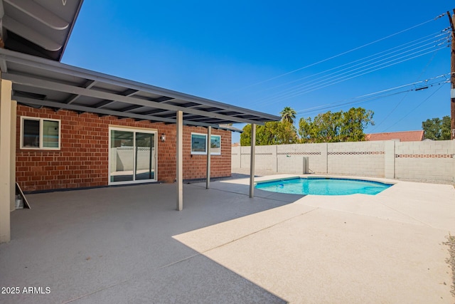view of swimming pool with a fenced backyard, a fenced in pool, and a patio