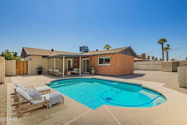view of pool with a fenced in pool, a fenced backyard, a gate, an outdoor hangout area, and a patio