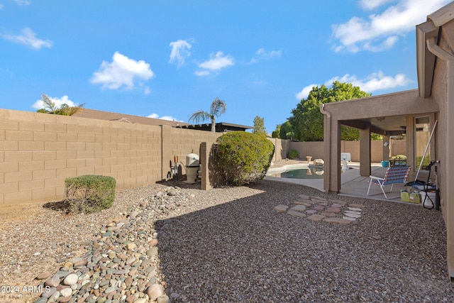 view of yard with a fenced in pool and a patio area