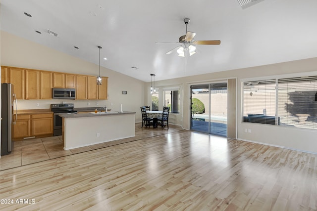 kitchen with ceiling fan, an island with sink, appliances with stainless steel finishes, decorative light fixtures, and light hardwood / wood-style floors