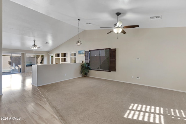 unfurnished living room with ceiling fan, high vaulted ceiling, and light colored carpet