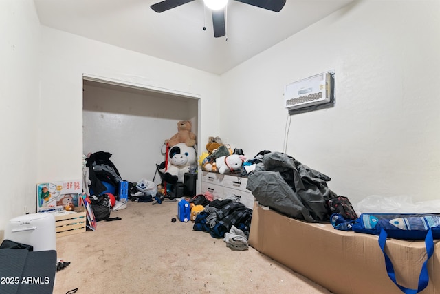 bedroom with carpet, ceiling fan, and a wall unit AC