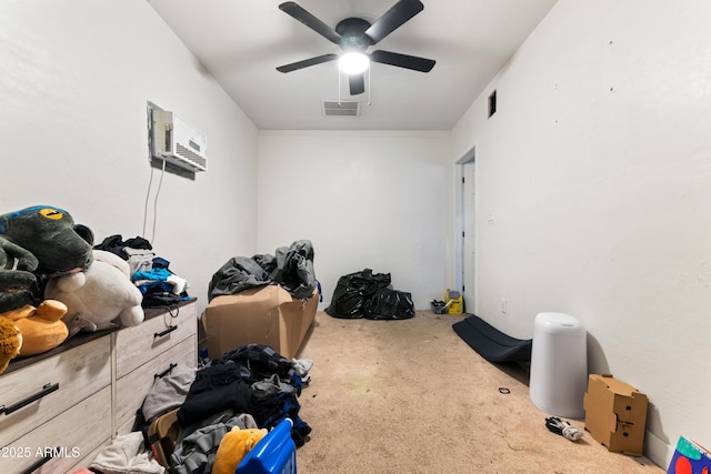 carpeted bedroom featuring ceiling fan and a wall mounted air conditioner