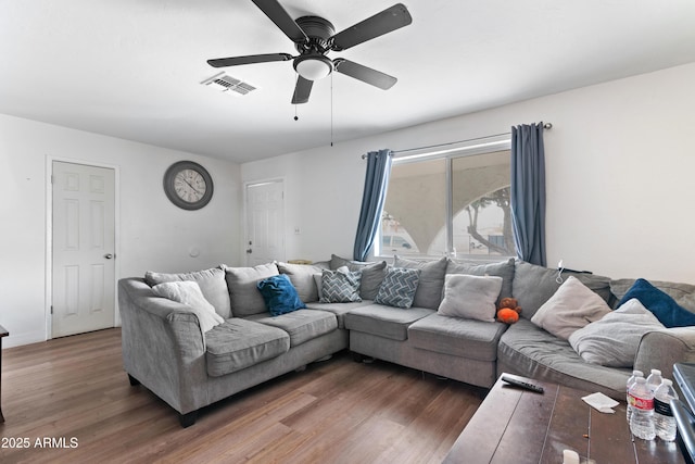 living room with ceiling fan and dark hardwood / wood-style flooring