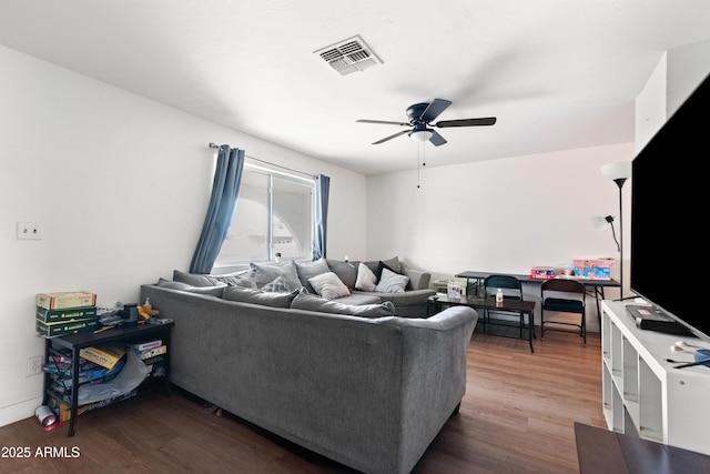 living room featuring ceiling fan and hardwood / wood-style floors