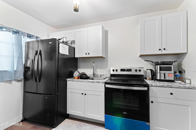 kitchen with white cabinetry, black refrigerator with ice dispenser, and stainless steel range with electric stovetop