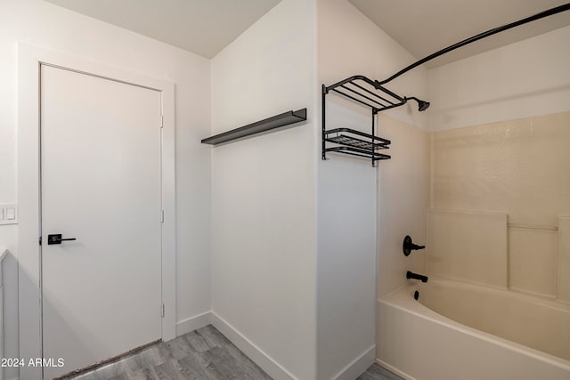 bathroom featuring shower / bath combination and hardwood / wood-style flooring