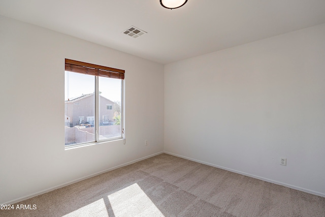 unfurnished room featuring light carpet