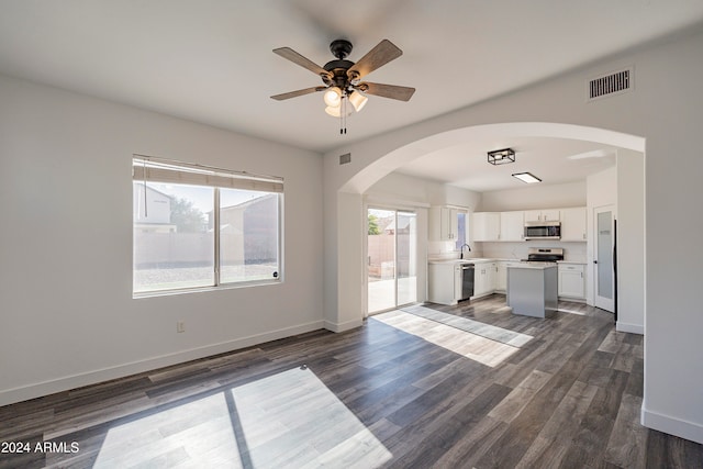 unfurnished living room featuring ceiling fan, dark hardwood / wood-style floors, and sink