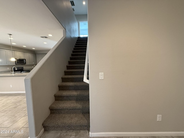 staircase featuring tile patterned floors