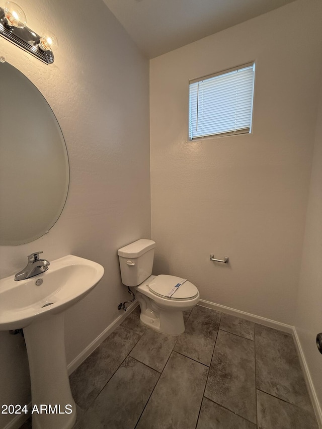 bathroom featuring tile patterned flooring and toilet