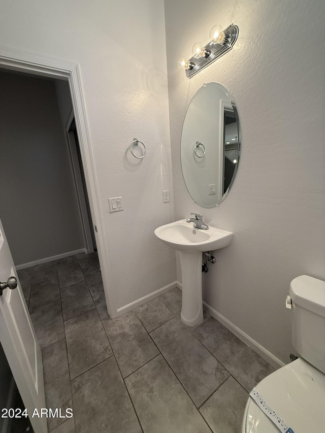 bathroom featuring tile patterned flooring and toilet