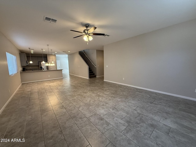 unfurnished living room with ceiling fan