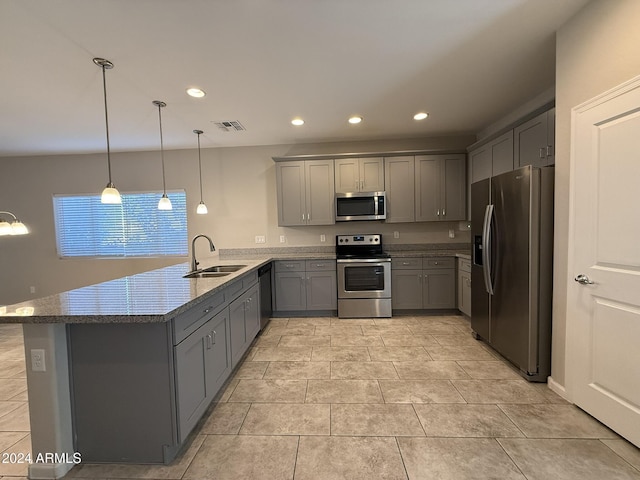 kitchen featuring gray cabinetry, sink, hanging light fixtures, stainless steel appliances, and kitchen peninsula