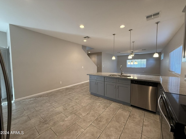 kitchen with ceiling fan, sink, decorative light fixtures, and appliances with stainless steel finishes