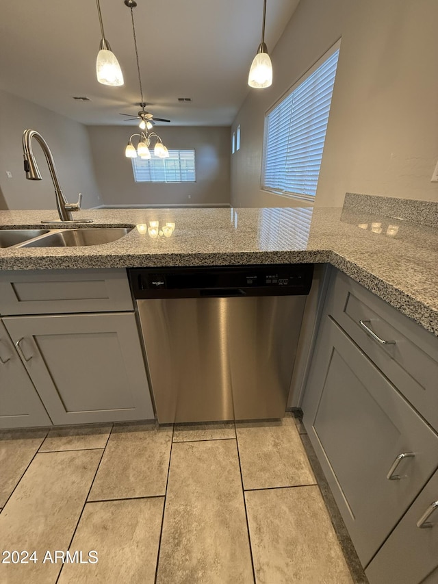 kitchen with ceiling fan, dishwasher, sink, light stone counters, and gray cabinets