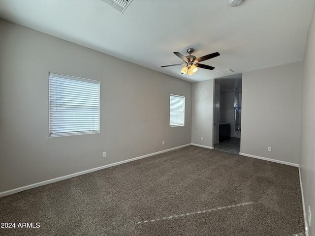 carpeted spare room featuring ceiling fan